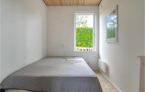 a bedroom with a bed in a room with a window at Three-Bedroom Holiday Home In Farso in Farsø