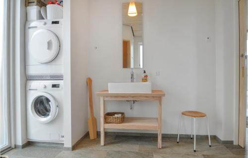 a bathroom with a sink and a washing machine at Three-Bedroom Holiday Home In Farso in Farsø