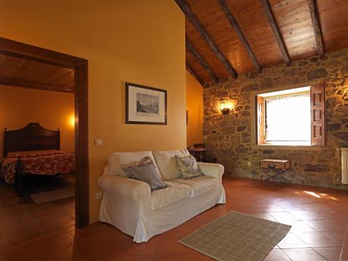 a living room with a white couch and a window at Quinta da Casa Alta in Valença