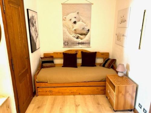 a bedroom with a bed with a picture of a polar bear at Studio Megève, 1 pièce, 4 personnes - FR-1-453-82 in Megève