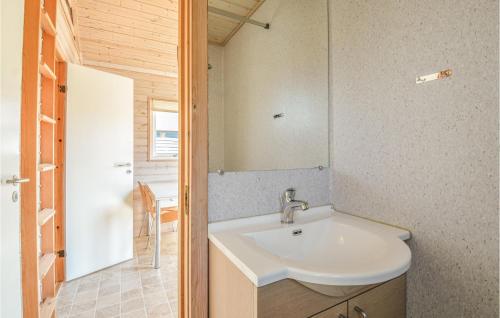 a bathroom with a sink and a mirror at Hytte 19 in Thyborøn