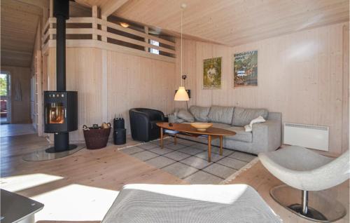 a living room with a couch and a wood stove at Four-Bedroom Holiday Home In Fjerritslev in Fjerritslev