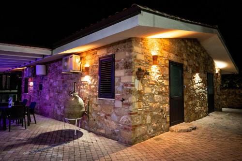 a stone building with lights on the side of it at RhelizeOne & Spa جميل in Palermo