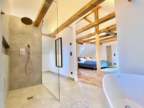 a bathroom with a glass shower and a bedroom at Snug Stays 4 - Design Villa mit Garten zentral, ruhig, 400m zum Ammersee in Dießen am Ammersee