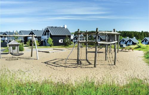 an empty playground with two swings in the sand at Søhøjlandet in Gjern