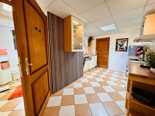 a kitchen with a door and a tile floor at Premium Ferienwohnung Ulf-Dieter Kunstmann in Kremmen