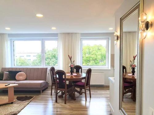 a living room with a table and a couch at Cozy 3 bedroom apartament in town centre of Joniškis in Joniškis