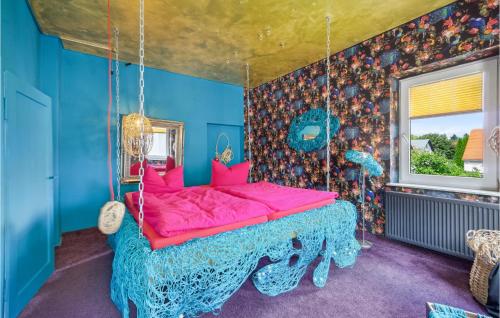 a bedroom with a pink bed in a blue room at 1 Bedroom Lovely Apartment In Neugersdorf-ebersbach 