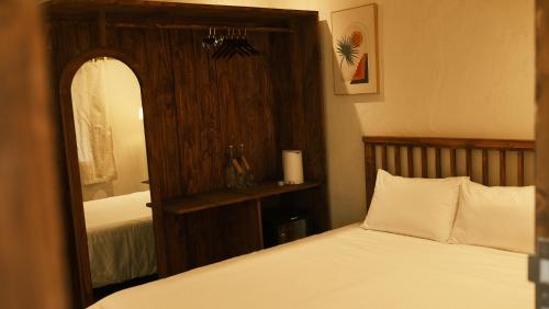 a bedroom with a bed and a large mirror at Vũ House Phú Yên- Boutique Room & Breakfast in Tuy Hoa