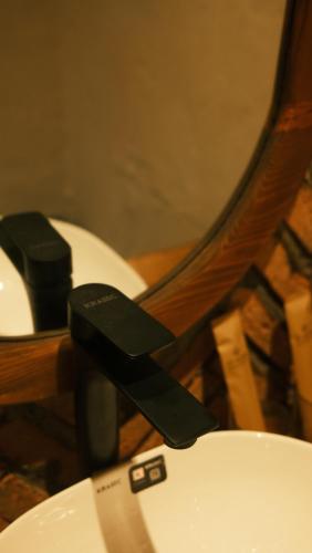 a close up of a toilet with a black handle at Vũ House Phú Yên- Boutique Room & Breakfast in Tuy Hoa