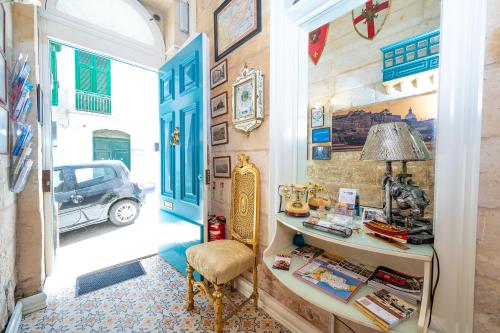 a hallway with a table and a car in a room at Valletta Apartments 19 in Valletta