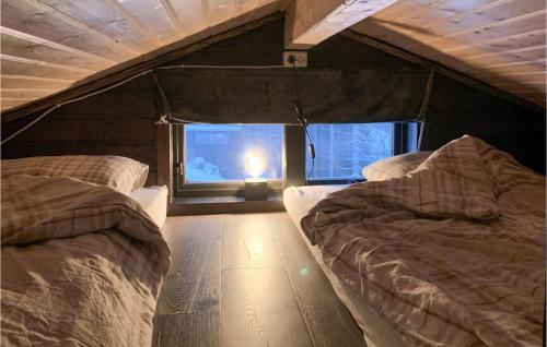 a room with two beds and a window at Cozy Home In Stordal With House A Mountain View in Stordal