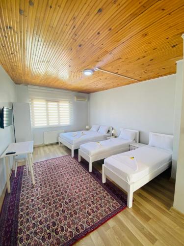 a room with three beds and a wooden ceiling at Stylish Hotel Old City in Istanbul