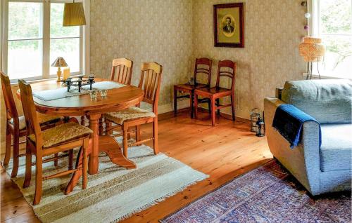 a living room with a wooden table and chairs at Pet Friendly Home In Boxholm With Kitchen in Blåvik