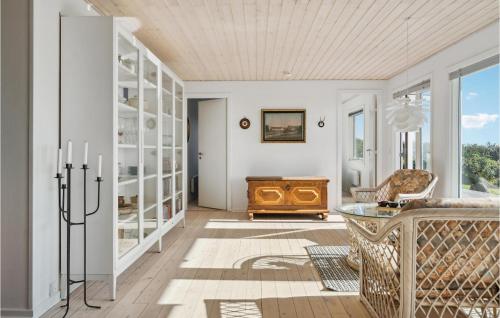 a living room with white walls and a wooden ceiling at Awesome Home In Ebberup With Kitchen in Ebberup
