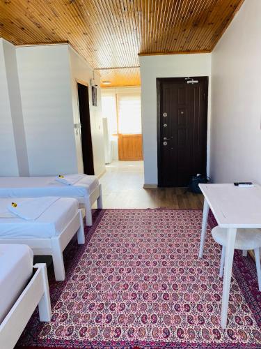 a room with three beds and a red rug at Stylish Hotel Old City in Istanbul