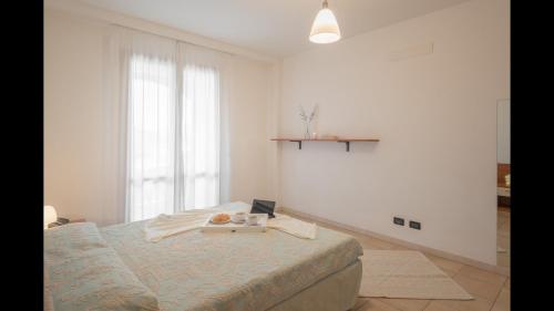 a bedroom with a bed with a tray of food on it at Stylish Residence Le Fontane no2503 in Villasimius