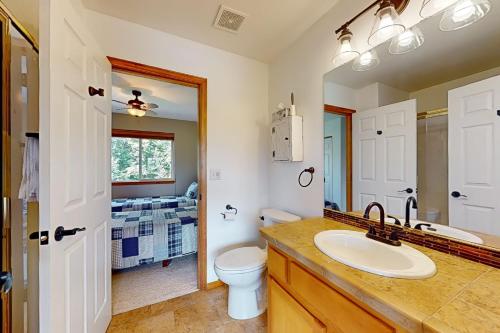 a bathroom with a sink and a toilet and a mirror at The Golden Pheasant in Redmond
