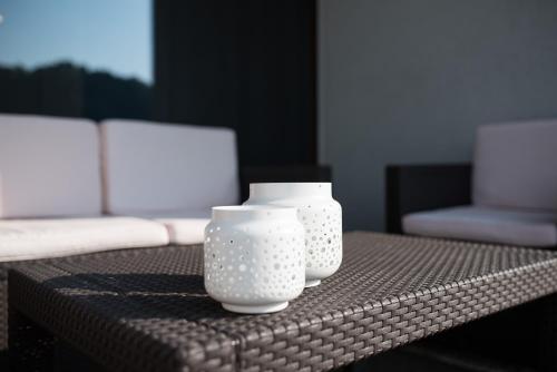 three white vases sitting on top of a table at KELLER APARTMENT in Sulz am Neckar