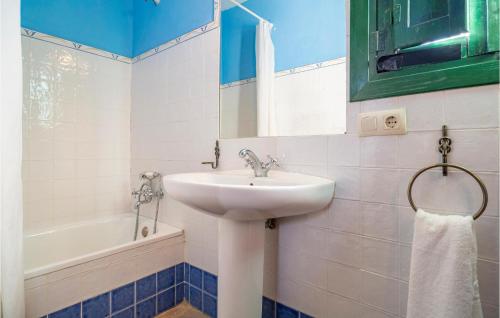 een witte badkamer met een wastafel en een bad bij 2 Bedroom Pet Friendly Home In Teba in Teba