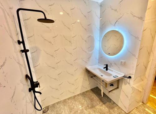 a bathroom with a sink and a mirror at Homtel Signature Suites in Islamabad