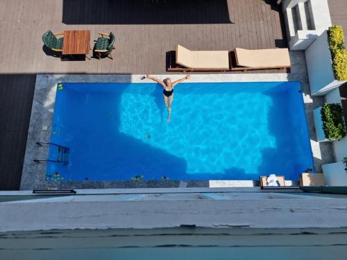 a person jumping into a swimming pool at Loop Hotel Bosphorus İstanbul in Istanbul