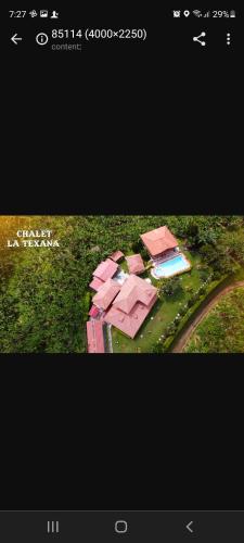 a picture of a house with a pool in the grass at Chalet la texana in Filandia