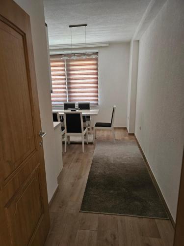 an empty room with a desk and a table at Dardania-Home in Prizren