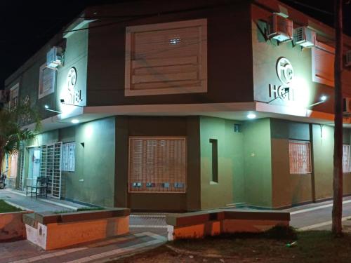 a house with a lit up facade at night at Hotel FG in Termas de Río Hondo
