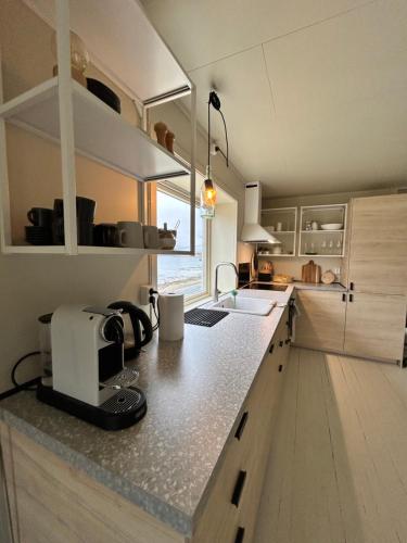 a kitchen with a sink and a counter top at Casa Lofoten Ramberg Beach Sauna Surfing Kvalvika Reine in Ramberg