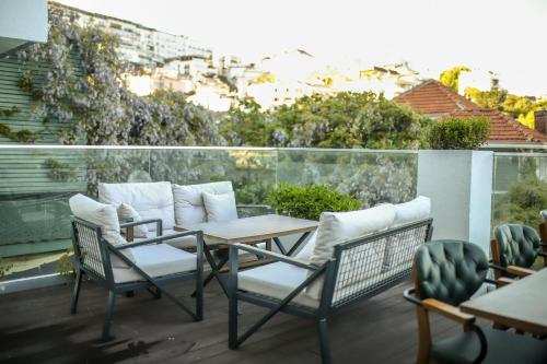 a patio with chairs and a table on a balcony at Loop Hotel Bosphorus İstanbul in Istanbul