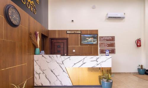 a reception area of a hospital with a clock on the wall at Treebo Trend The Rove in Madikeri