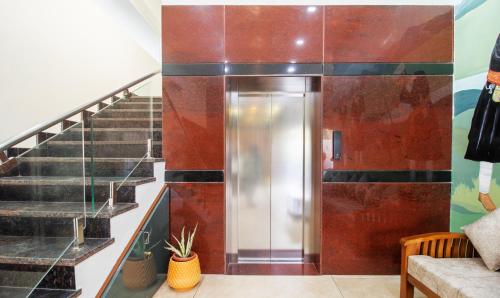 a hallway with stairs and a elevator in a building at Treebo The Rove, Coorg in Madikeri