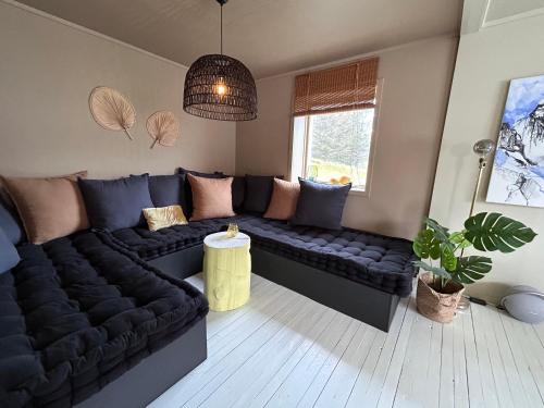 a living room with a couch and a table at Casa Lofoten Ramberg Beach Sauna Surfing Kvalvika Reine in Ramberg