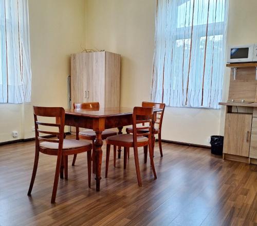 a dining room table and chairs in a room at Apartmán Nad hradem in Týnec nad Sázavou