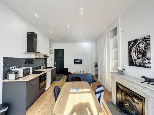 eine Küche und ein Wohnzimmer mit einem Tisch im Zimmer in der Unterkunft cosy appart - Préfecture Lyon - Servient 1 in Lyon
