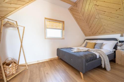 Una cama o camas en una habitación de Bliżej GÓR- nowoczesne domki w górach z balią