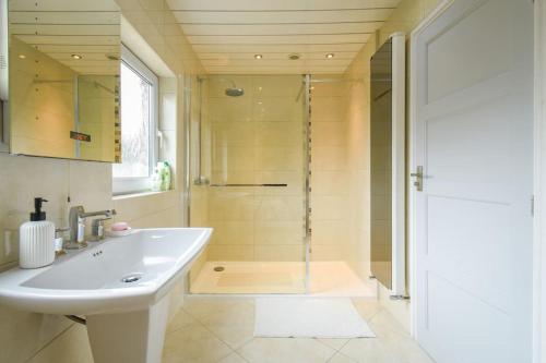 a bathroom with a sink and a shower at Luxurious & Tranquil Riverside Getaway in Great Harwood
