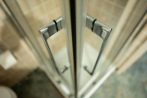 a close up of a metal door in a bathroom at RhelizeOne & Spa جميل in Palermo