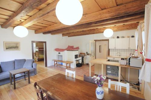 a living room with a couch and a table at Roubenka U Andělů, Šumava in Kašperské Hory