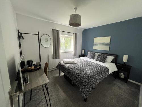 a bedroom with a bed and a table and a window at 2 x King & 1 Single bedroom - Sleeps 5 - Kitchen - by Canal in Barton under Needwood