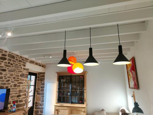 a group of three lights hanging from a ceiling at Tannerie 4 in Lanvallay