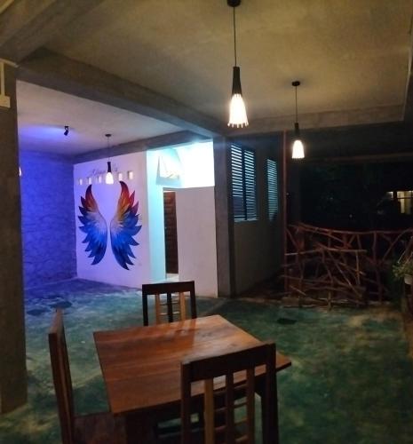 a dining room with a table and a butterfly wall at Kithaya Ella in Ella