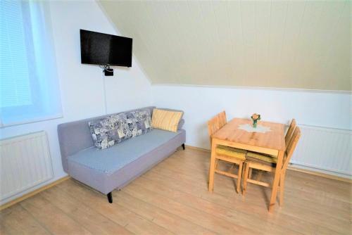 a living room with a couch and a table at Kmetija Podobnik in Idrija