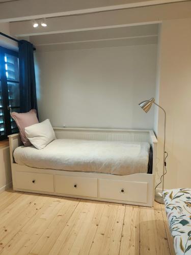 a bedroom with a bed in a room with a lamp at Tannerie 4 in Lanvallay