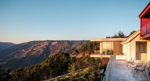 a house with a balcony with a view of the mountains at Casa de São Lourenço - Burel Panorama Hotel - member of Design Hotels in Manteigas