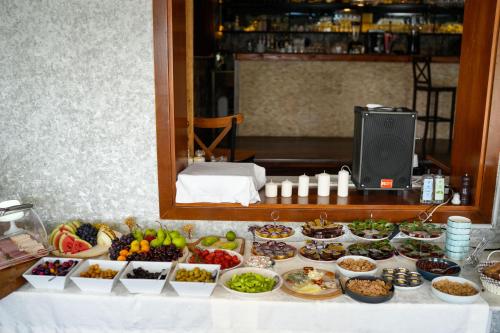 a buffet of food on a table in front of a mirror at Loop Hotel Bosphorus İstanbul in Istanbul
