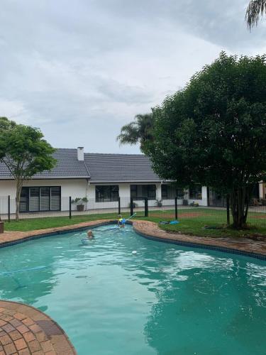 a person swimming in a large swimming pool at Market on 5 in Piet Retief
