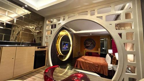 a room with a bedroom with a bed and a mirror at Shining Motel in Taichung