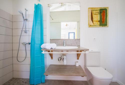 a bathroom with a sink and a toilet at Iguane House Villas & Micro Spa in Sainte-Anne
